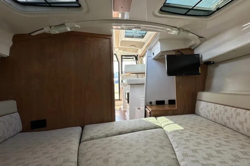  Yacht Photos Pics Interior of 2026 Cutwater C-248 Coupe, featuring cozy cabin with bed and TV.