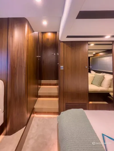  Yacht Photos Pics Luxurious interior of 2023 Fairline Targa 45 Open yacht with wooden finishes and cozy bedding.