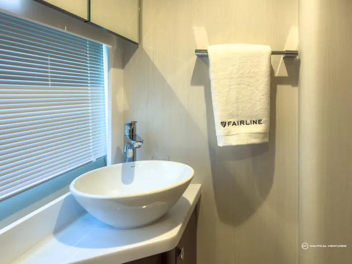  Yacht Photos Pics Modern bathroom in 2023 Fairline Targa 45 Open yacht with sink and branded towel.