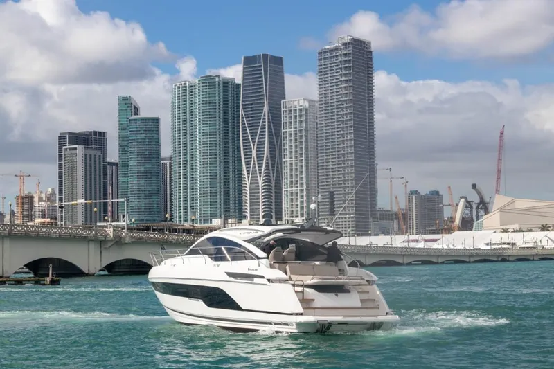  Yacht Photos Pics 2023 Fairline Targa 45 Open yacht cruising near city skyline.