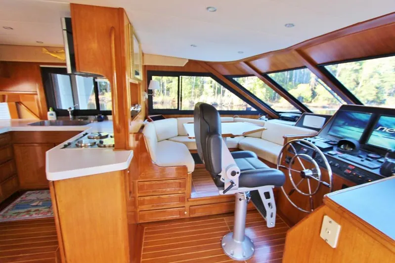 Slainte Yacht Photos Pics Interior of 1992 Tollycraft 53 Motor Yacht with helm, seating, and wooden finishes.