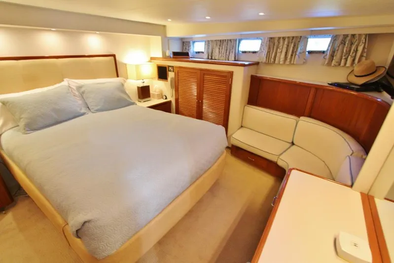 Slainte Yacht Photos Pics Luxurious bedroom interior of 1992 Tollycraft 53 Motor Yacht with cozy bed and seating area.