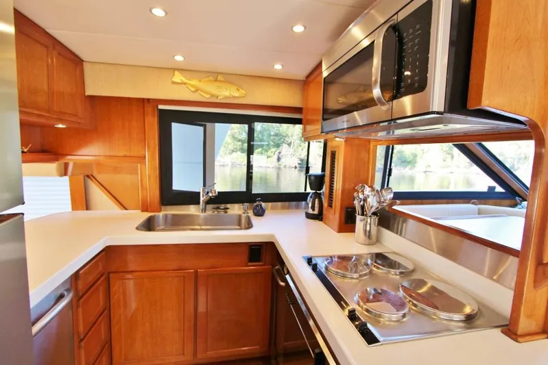 Slainte Yacht Photos Pics Luxurious kitchen interior of 1992 Tollycraft 53 Motor Yacht with modern appliances.