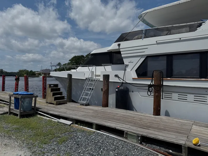 Slainte Yacht Photos Pics Tollycraft 53 Motor Yacht 1992 docked at a marina under a cloudy sky.