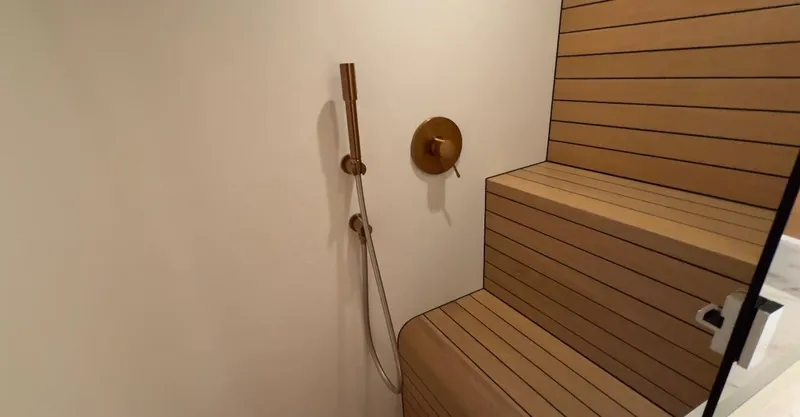 Eva Yacht Photos Pics Shower area in 2022 Van der Valk Waterdream California 52 yacht, featuring wooden seating.