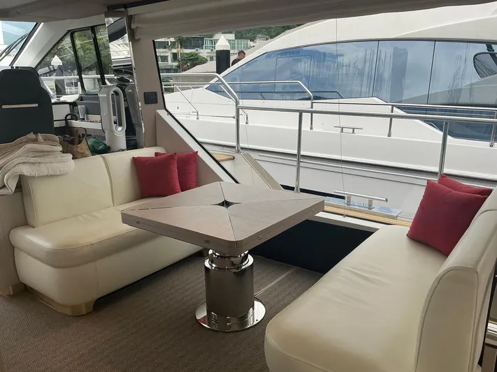 Asia 3 Yacht Photos Pics Luxurious interior of 2019 Azimut 60 yacht with white seating and red cushions.