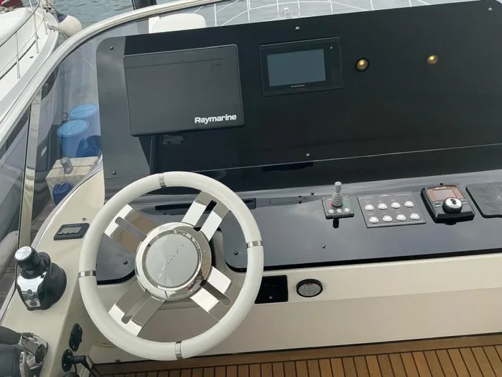 Asia 3 Yacht Photos Pics Cockpit of 2019 Azimut 60 yacht with steering wheel and Raymarine navigation system.