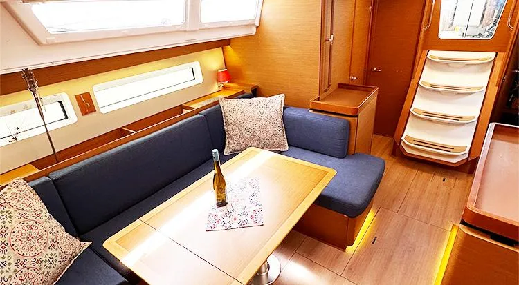 Nautical Dreamer Yacht Photos Pics Interior of 2019 Jeanneau Sun Odyssey 490 yacht with cozy seating and elegant table setting.