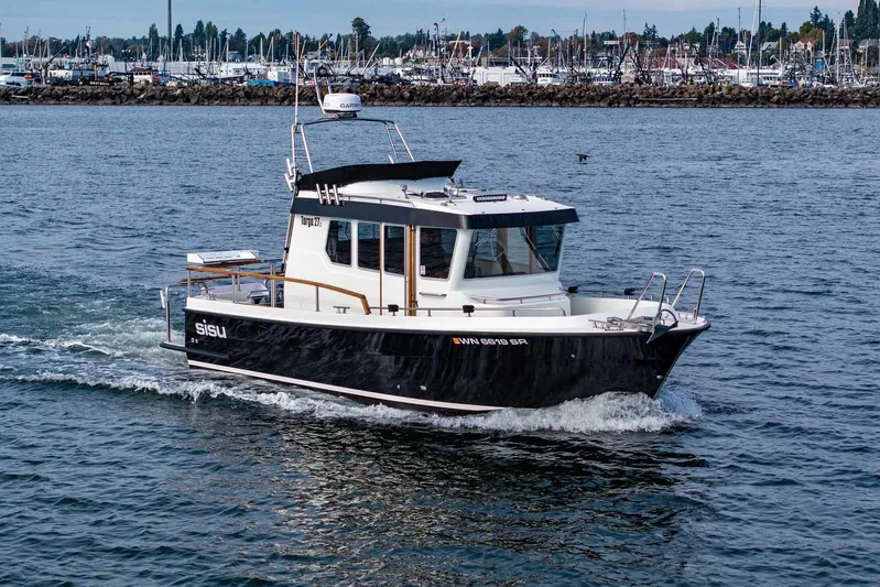  Yacht Photos Pics 2019 Targa 27.2 boat cruising on water near marina, showcasing sleek design and functionality.