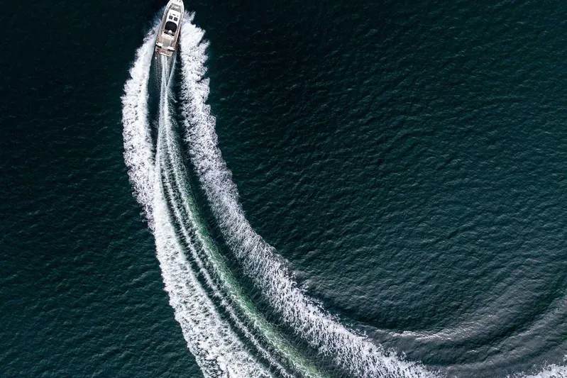 Yacht Photos Pics Aerial view of 2019 Targa 27.2 boat creating a curved wake on the water.
