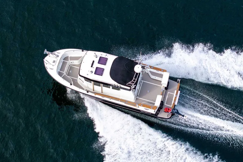  Yacht Photos Pics Aerial view of 2019 Targa 27.2 boat cruising on open water.