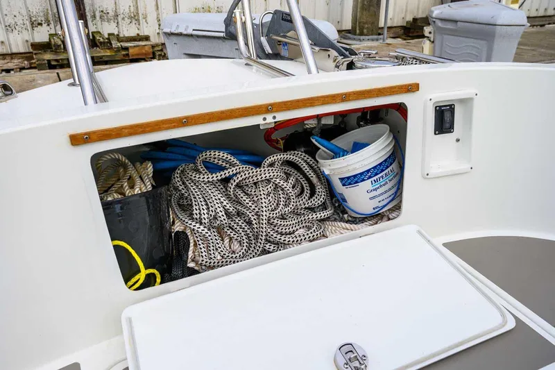  Yacht Photos Pics Storage compartment of a 2019 Targa 27.2 boat with ropes and cleaning supplies.