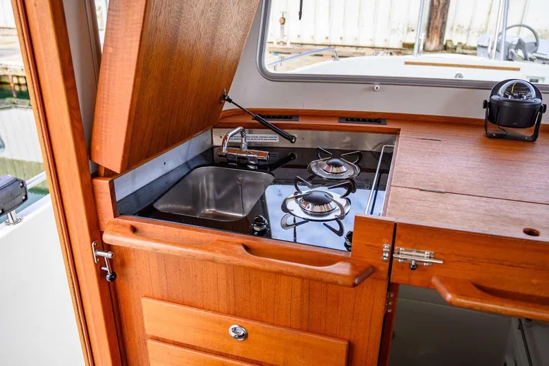  Yacht Photos Pics Compact kitchen area on 2019 Targa 27.2 boat with stove and sink.