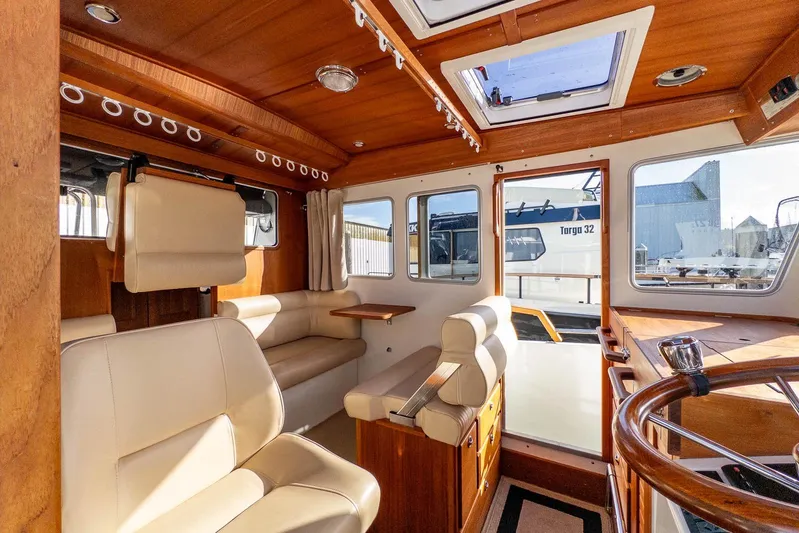  Yacht Photos Pics Interior of 2019 Targa 27.2 boat with wooden finish and beige seating.