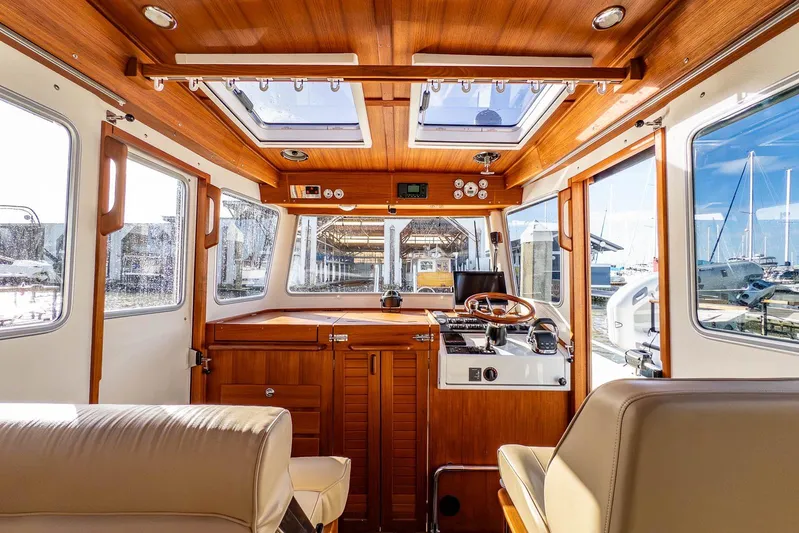  Yacht Photos Pics Interior of 2019 Targa 27.2 boat with wooden finish and modern controls.