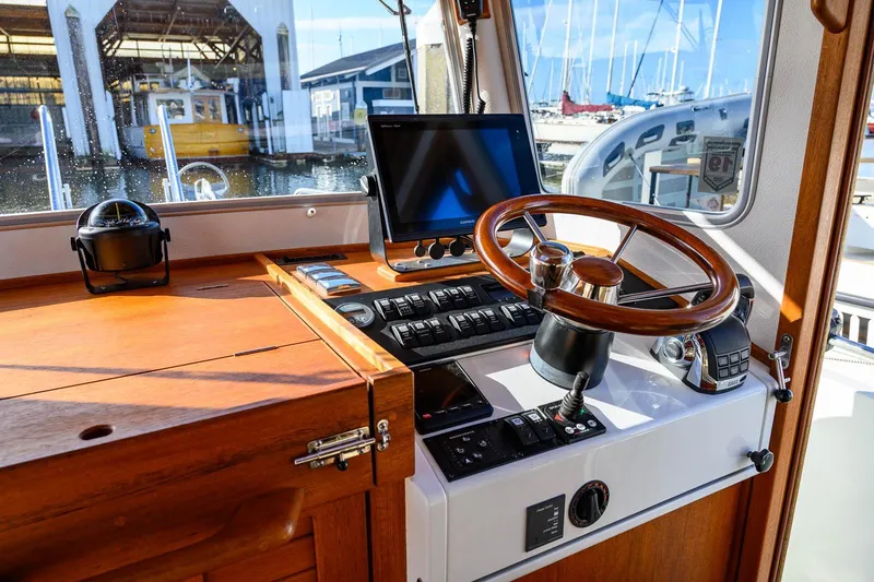  Yacht Photos Pics 2019 Targa 27.2 boat helm with wooden steering wheel and navigation equipment.