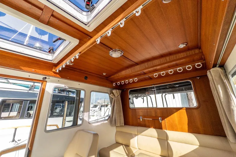  Yacht Photos Pics Interior of 2019 Targa 27.2 boat with wooden ceiling and beige seating.
