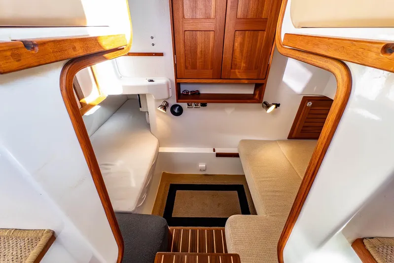  Yacht Photos Pics Cozy interior of 2019 Targa 27.2 boat with wooden accents and seating area.