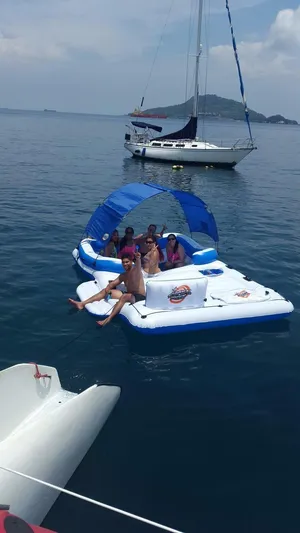 Sun Cat Yacht Photos Pics People relaxing on an inflatable raft near a Custom Sunrise 59 Day Charter sailboat, 2011 model.