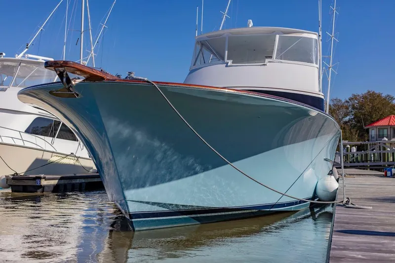  Yacht Photos Pics Custom Carolina 66 yacht, 2005 model, docked in a marina under clear blue skies.
