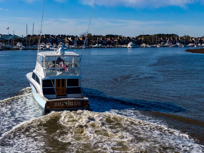  Yacht Photos Pics Custom Carolina 66 yacht "Big Blue" cruising in a marina, 2005 model.