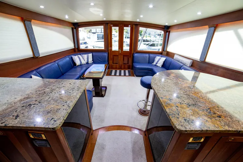  Yacht Photos Pics Luxurious interior of 2005 Custom Carolina 66 yacht with blue seating and granite countertops.
