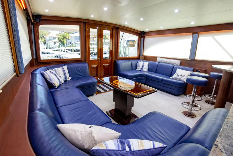  Yacht Photos Pics Luxurious interior of 2005 Custom Carolina 66 yacht with blue leather seating and elegant decor.