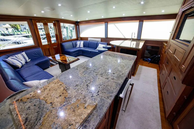  Yacht Photos Pics Luxurious interior of a 2005 Custom Carolina 66 yacht with granite countertops and plush seating.