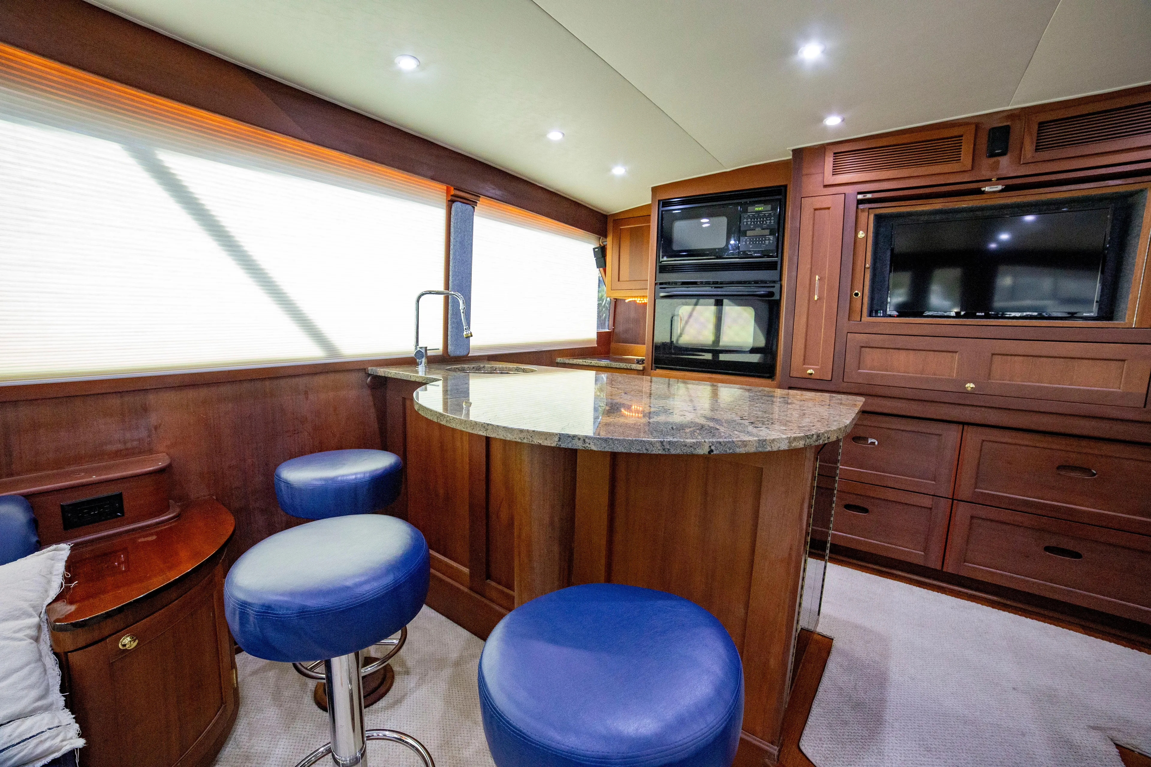  Yacht Photos Pics Luxurious interior of 2005 Custom Carolina 66 yacht with modern kitchen and seating area.
