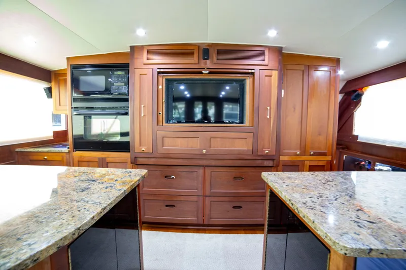  Yacht Photos Pics Luxurious interior of 2005 Custom Carolina 66 yacht with wood cabinetry and granite countertops.