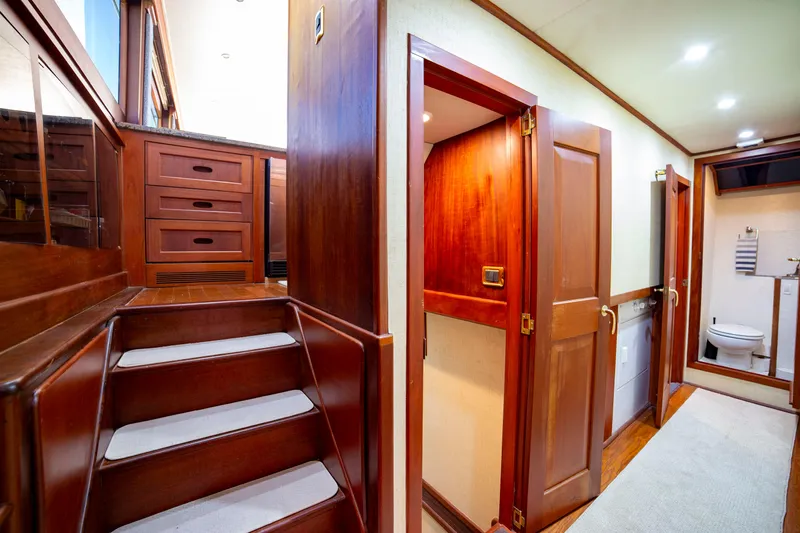  Yacht Photos Pics Interior of 2005 Custom Carolina 66 yacht with wooden stairs and hallway.