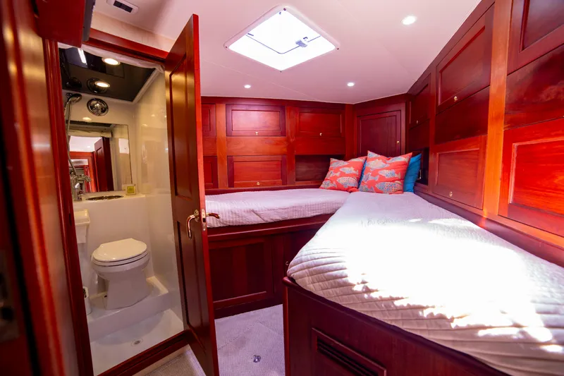  Yacht Photos Pics Luxurious cabin interior of 2005 Custom Carolina 66 yacht with twin beds and ensuite bathroom.