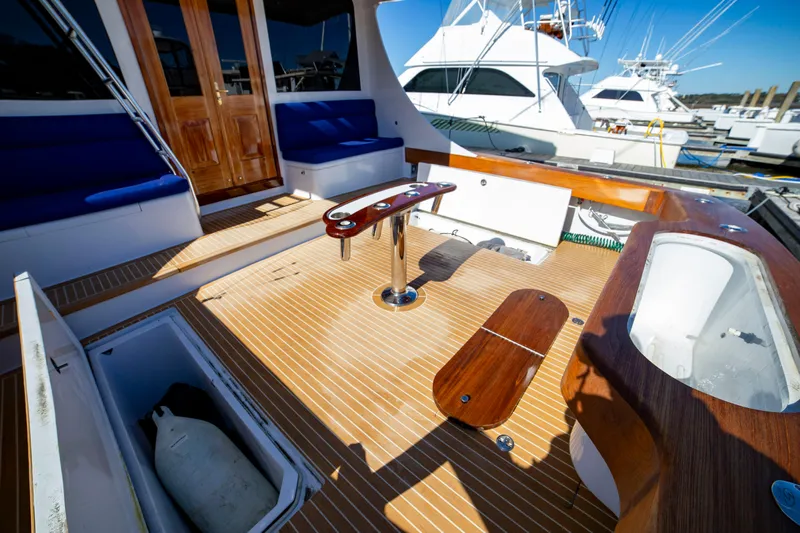  Yacht Photos Pics Spacious deck of 2005 Custom Carolina 66 yacht with wooden flooring and seating.