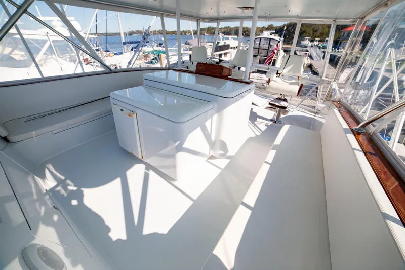  Yacht Photos Pics Spacious deck of 2005 Custom Carolina 66 yacht, featuring sleek white seating and storage.