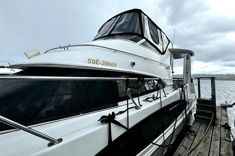  Yacht Photos Pics 2003 Carver 396 Motor Yacht docked on a cloudy day.