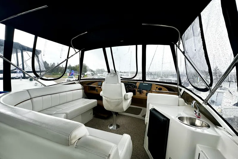  Yacht Photos Pics Interior of 2003 Carver 396 Motor Yacht with white seating and helm station.