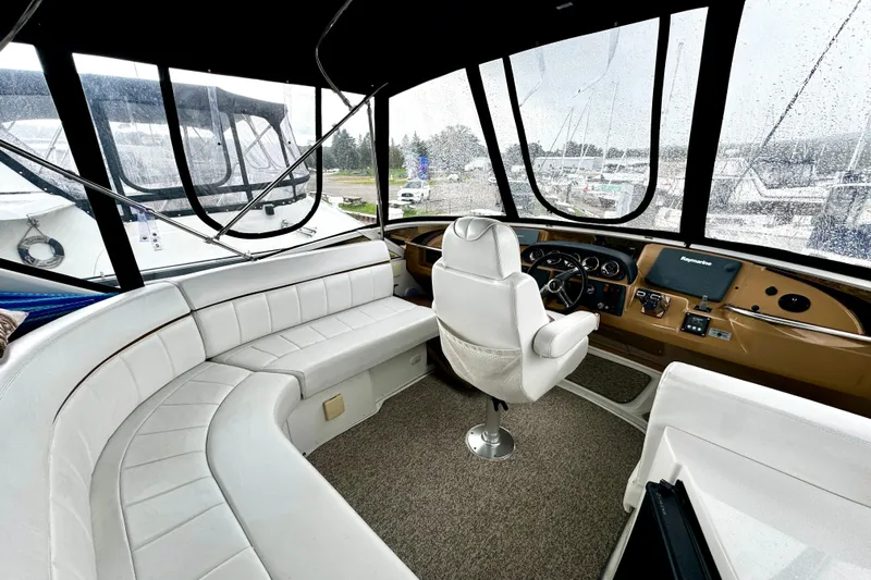  Yacht Photos Pics 2003 Carver 396 Motor Yacht interior with white seating and helm station.