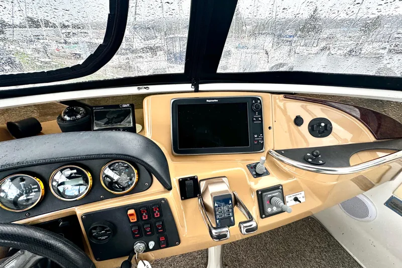  Yacht Photos Pics 2003 Carver 396 Motor Yacht helm with navigation instruments and controls in rainy weather.