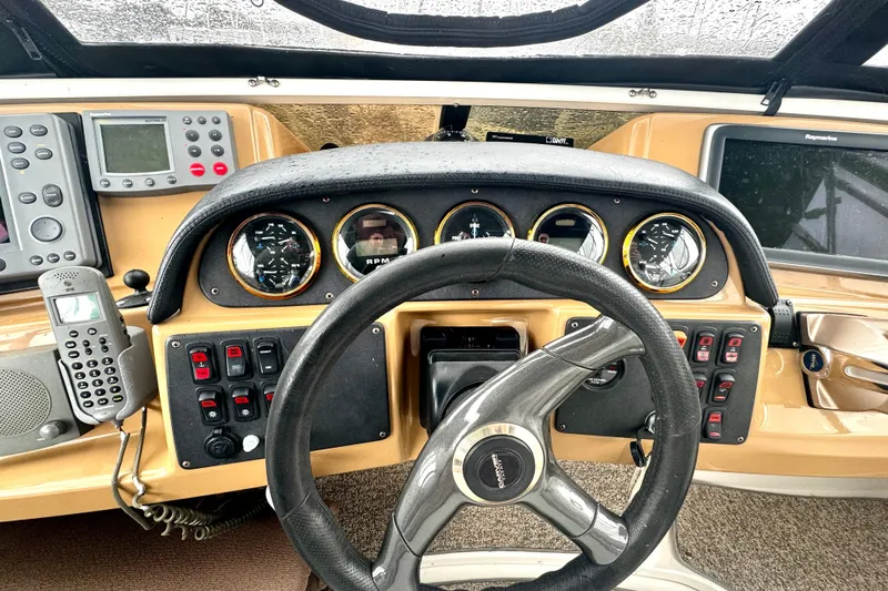  Yacht Photos Pics 2003 Carver 396 Motor Yacht helm with steering wheel, gauges, and navigation equipment.