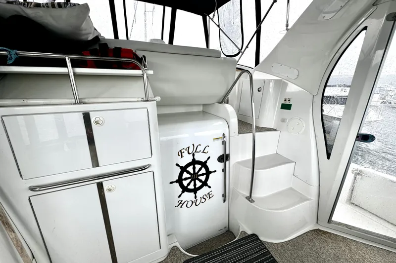  Yacht Photos Pics 2003 Carver 396 Motor Yacht interior with "Full House" sign, white cabinetry, and stairs.