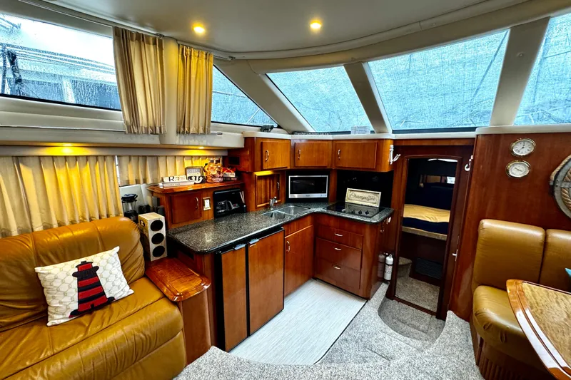  Yacht Photos Pics Luxurious 2003 Carver 396 Motor Yacht interior with modern kitchen and cozy seating area.