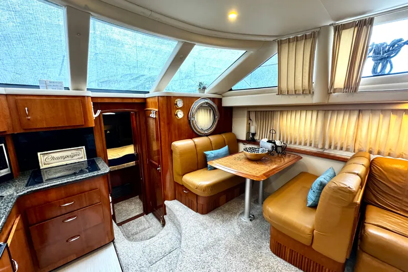  Yacht Photos Pics Luxurious interior of 2003 Carver 396 Motor Yacht with leather seating and dining area.