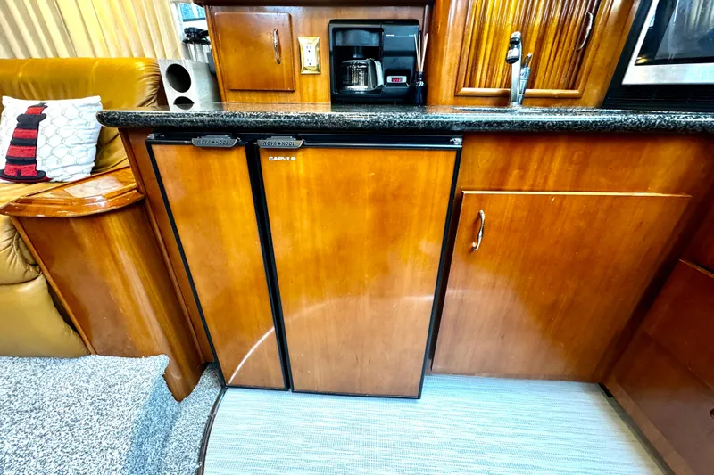  Yacht Photos Pics 2003 Carver 396 Motor Yacht interior with wooden cabinetry and compact kitchen appliances.