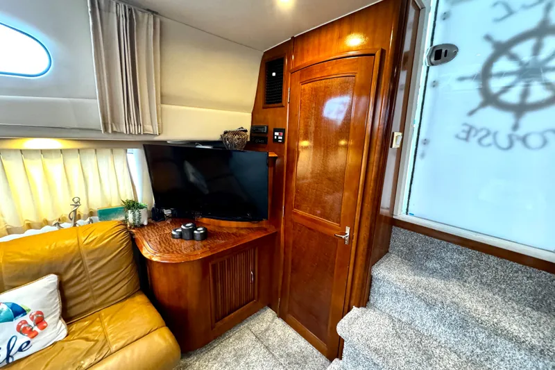  Yacht Photos Pics Interior of 2003 Carver 396 Motor Yacht with TV, wooden cabinetry, and cozy seating.