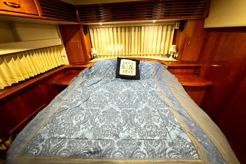  Yacht Photos Pics Luxurious 2003 Carver 396 Motor Yacht bedroom with elegant bedding and nautical decor.