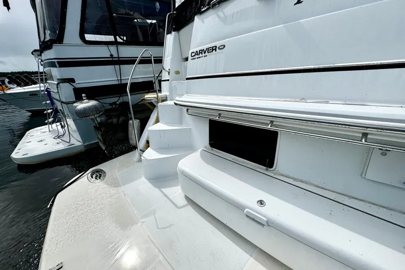  Yacht Photos Pics 2003 Carver 396 Motor Yacht docked, showcasing sleek design and spacious deck area.