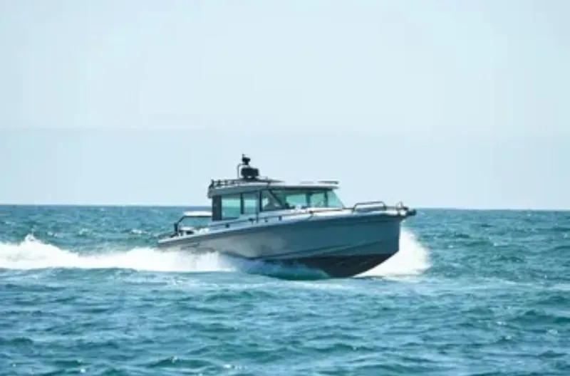Problem Child Yacht Photos Pics 2017 Axopar 37 Cross Cabin boat cruising on open sea.