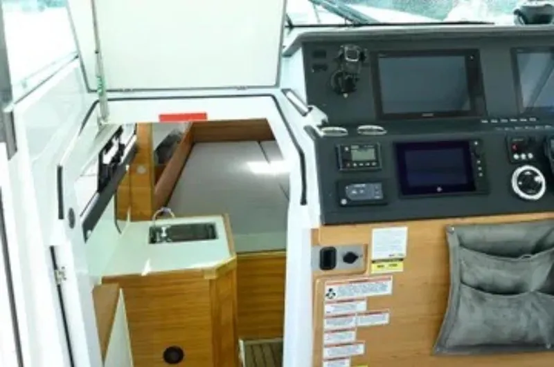 Problem Child Yacht Photos Pics Interior of 2017 Axopar 37 Cross Cabin with control panel and cabin entrance.