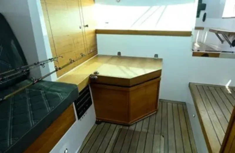 Problem Child Yacht Photos Pics Interior of 2017 Axopar 37 Cross Cabin with wooden cabinetry and seating.