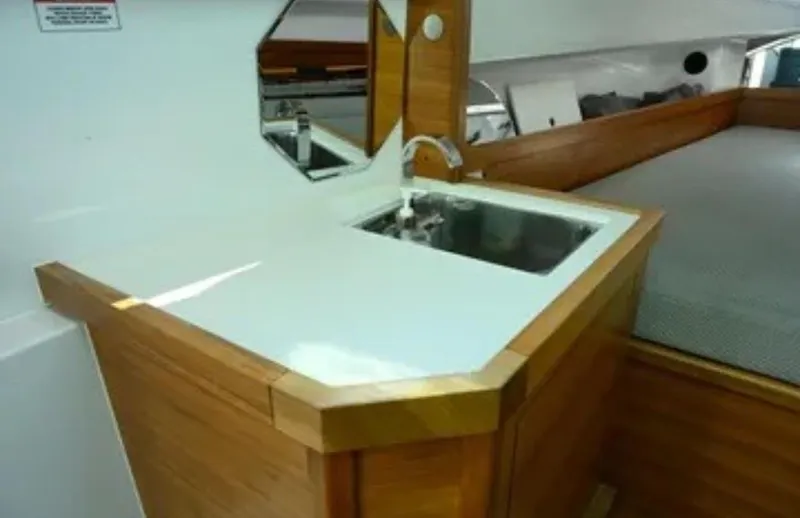 Problem Child Yacht Photos Pics 2017 Axopar 37 Cross Cabin interior with wooden sink area and bed.